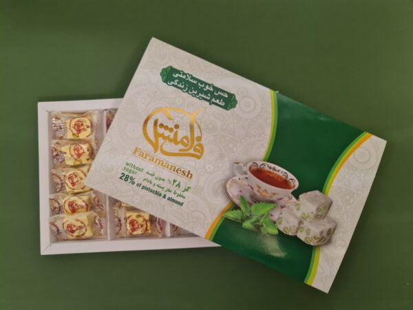 گز بدون قند و گلوتن فرامنش با مغز پسته و بادام بر روی پس زمینه سبز رنگ